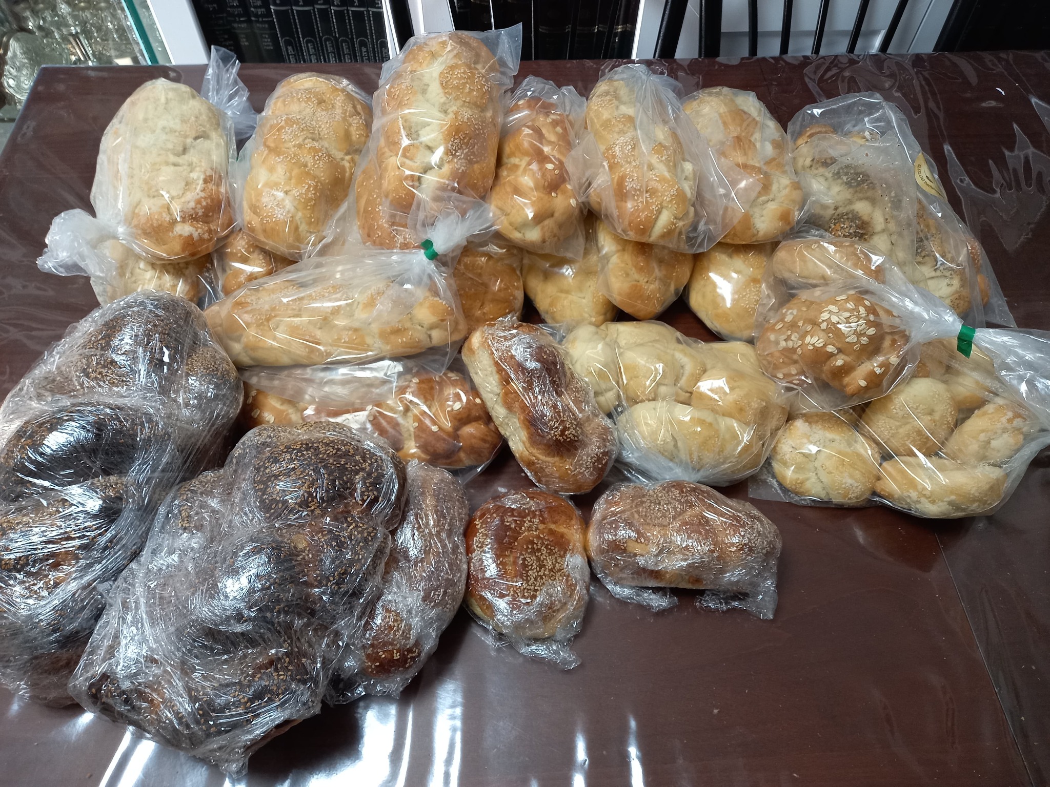 Many wrapped challos prepared for a soldiers' Shabbos delivery