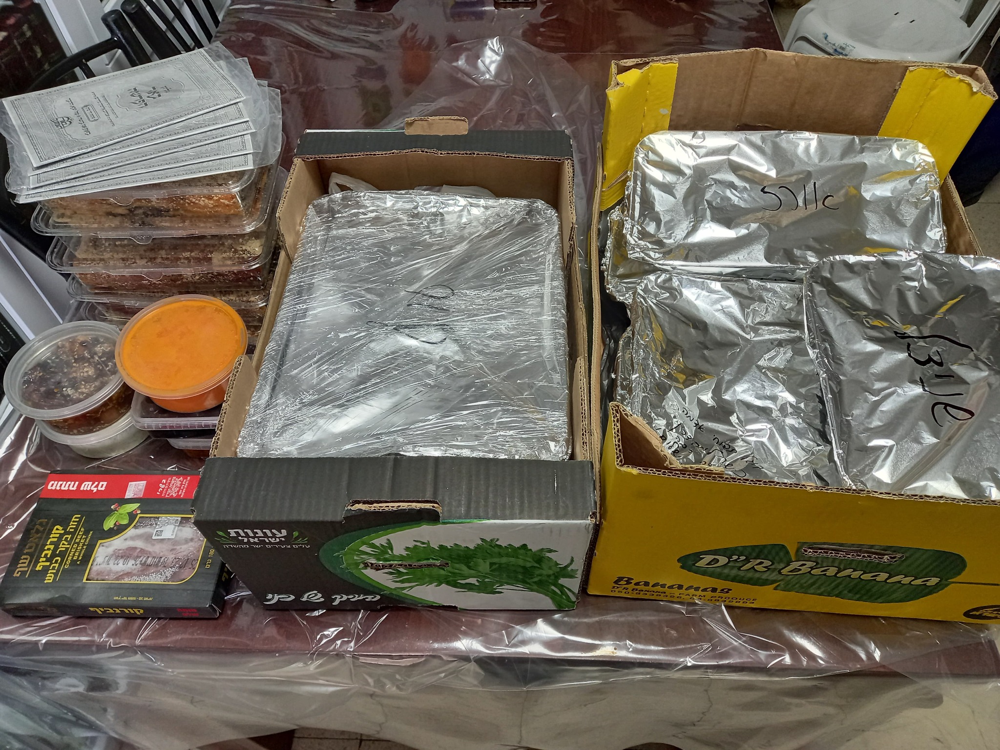 Boxes and trays of Shabbos food ready for transport